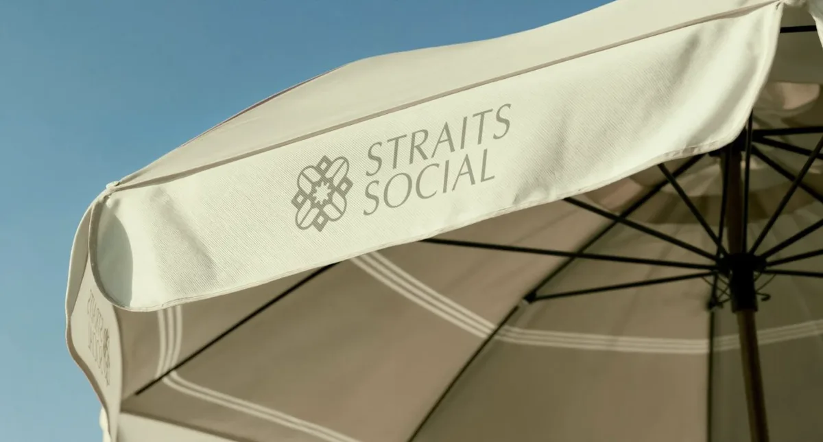 Straits Social outdoor parasol under a blue sky